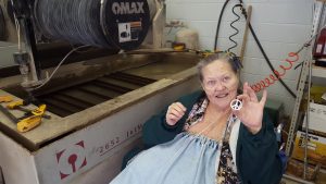 Mary Fenley holds an aluminum peace sign